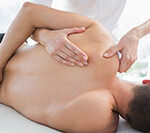 Physiotherapist massaging man